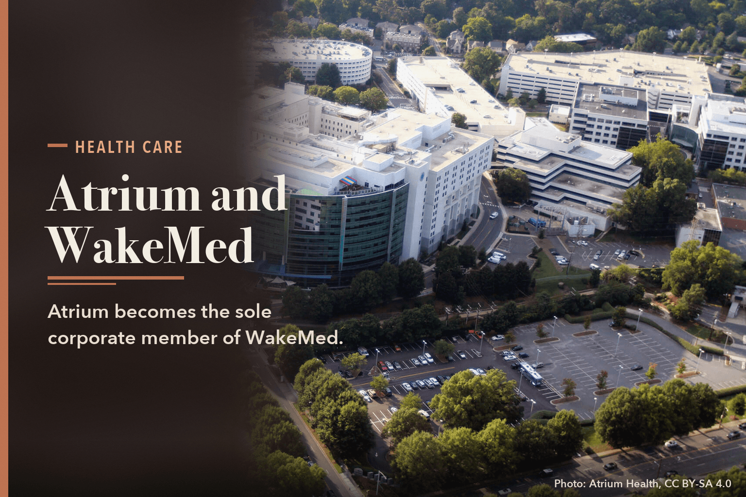 Aerial view of Carolinas Medical Center, Atrium Health's Charlotte hospital, beside a dark panel reading Atrium and WakeMed. Atrium becomes the sole corporate member of WakeMed.